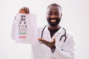 Portrait of smiling African American doctor who is showing eye examination test. photo