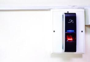 Black finger scanner device on white background for secure, access or entrance to area strict with copy space. Electronic and security equipment. photo