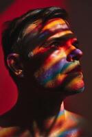 Close-up of man face with colored light and shadow pattern photo