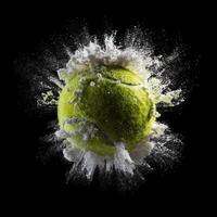 Tennis ball exploding with white powder on black background photo