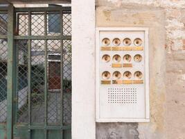 Old Apartment Intercom with Brass Buttons photo
