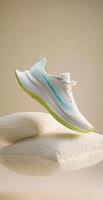 White running shoe floating above two large soft pillows, comfort and rest after exercising photo