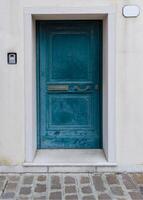 Old turquoise door with frame and intercom photo
