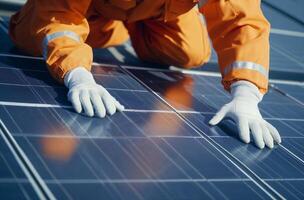 Worker Inspecting Solar Panel Close Up photo