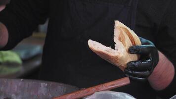 Chef skillfully combines chicken and bread in a cozy kitchen video