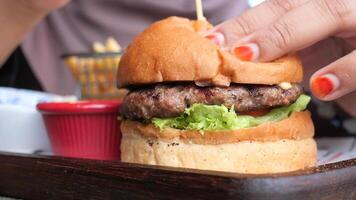 Delicious burger with fresh toppings enjoyed at local eatery video
