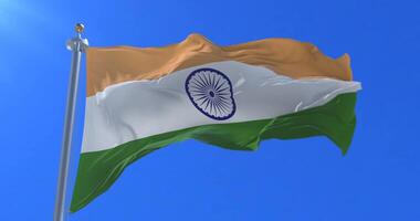 Flag of India waving at wind in slow in blue sky, loop video