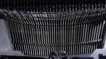 Keys hitting while typing an old qwerty typewriter video