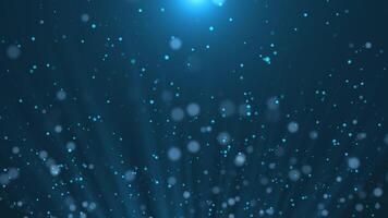 Flying abstract blue particles with light background. Magic dust. Glowing blue particles emanating from the beam of light. Bokeh blur effect video