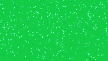 Abstract glowing particles of fall shiny twinkling glitter stars. Shiny sparkle rain. Chroma key - Green screen. Background New Year and Christmas. Seamless loop video