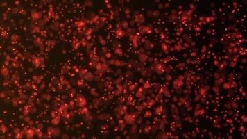 Background of orange particles from which a glow emanates. Mesmerizing bokeh effect. Colorful abstract background 4K, seamless loop. video