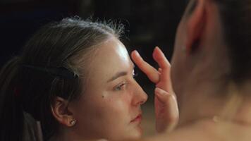 Lips are lined and filled with rich, creamy color. The model gently presses them together video
