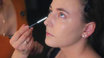 The stylist holds a mirror to reveal the final look. The model nods with a smile. Satisfaction is silent video