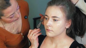 Cheekbones are enhanced with cream contour. Subtle shadows shape the face. Beauty meets dimension video