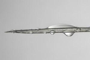 Water Droplets Adhere to a Surface, Forming a Capillary Bridge A Close-Up Study of Surface Tension and Cohesion, Demonstrating Liquid Behavior on a Planar Substrate with Minimal Gravity Effects. photo