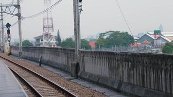 Hazy Railway Platform with Tracks and Urban Background video