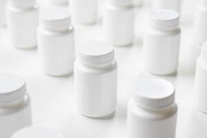Many white plastic bottles are arranged in a row photo