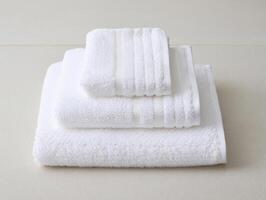 A stack of white towels on a table photo
