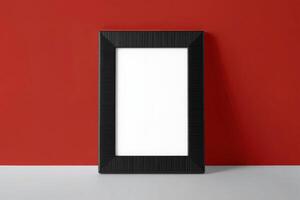 A blank white frame on a red wall photo