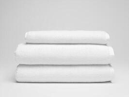 Three white towels stacked on top of each other photo