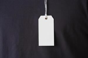 White blank price tag on a black t - shirt photo
