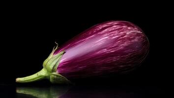 A purple eggplant on a black background photo