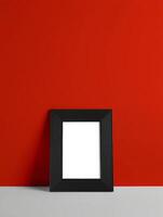 A black frame on a red wall photo