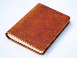 A brown leather journal with a white background photo