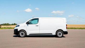 The new white van is parked on the road photo