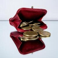 A red leather purse with coins inside photo