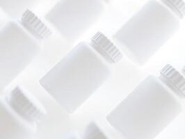 White plastic bottles with caps on a white background photo