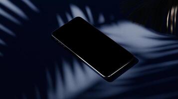 Black smartphone on a dark surface with palm leaves photo
