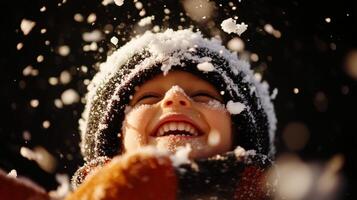 A child is smiling while playing in the snow photo