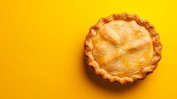 A classic apple pie on a bright and cheerful yellow photo
