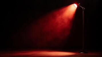 A red spotlight shines on a black floor photo