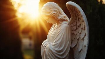 An angel statue is shown in the sunlight photo