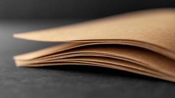 A stack of brown paper on a black surface photo
