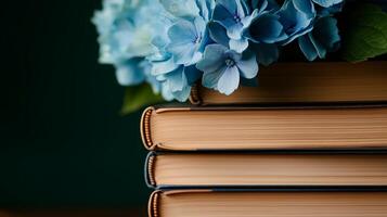 A stack of books with blue flowers sitting on top photo