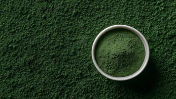 A bowl of green powder on a green background photo