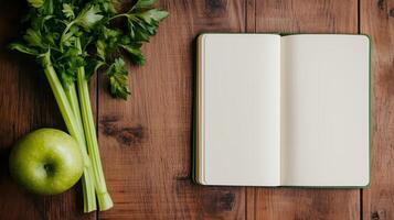 A Blank Notebook Open on Wooden Surface photo