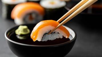 A bowl of sushi with chopsticks and salmon photo