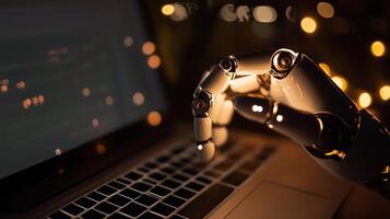 A robot hand is on a laptop computer photo