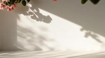 A white wall with pink flowers and shadows photo