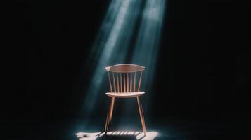 A chair in the dark with light shining through photo