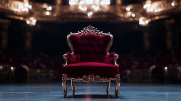 A red velvet chair sits in front of a stage photo