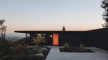 A modern home with a black exterior and a large window photo