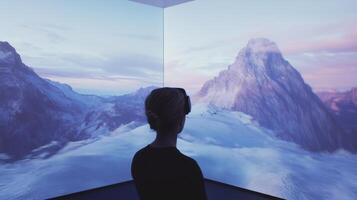 A person looking at a large screen with mountains photo