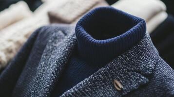 A blue sweater and a jacket are shown photo