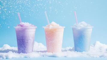 Three different colored smoothies in plastic cups on a blue background photo