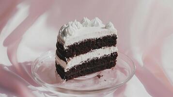 A piece of chocolate cake on a glass plate photo
